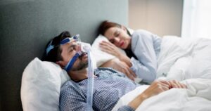 man with a sleep apnea mask on.